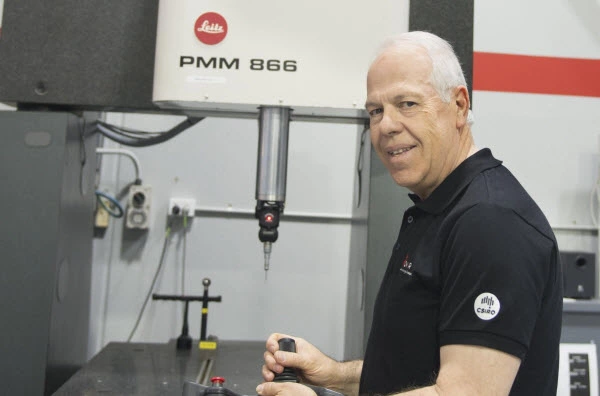 A man smiling while operating the machine